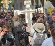 Gigi Becali a ieșit pe Calea Victoriei să „curețe” cu agheasmă după marșul LGBT: a purtat o cruce uriașă, apoi s-a oprit și a cântat