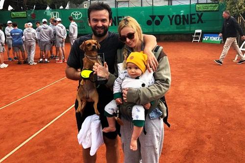 Florin Mergea, soția sa, Daiana, băiețelul lor, Noah, și câinele familiei, sărbătorind cu trofeul de la Meerbusch