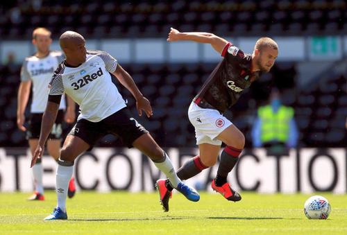 Andre Wisdom, depășit în acest duel de George Pușcaș // FOTO: Twitter.com/dcfcofficial