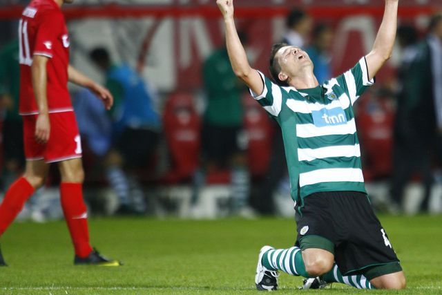 Anderson Polga, antigo central brasileiro do Sporting, celebra, de joelhos e braços erguidos aos céus, o apuramento do Sporting para o 'play-off' da Champions de 2009/10