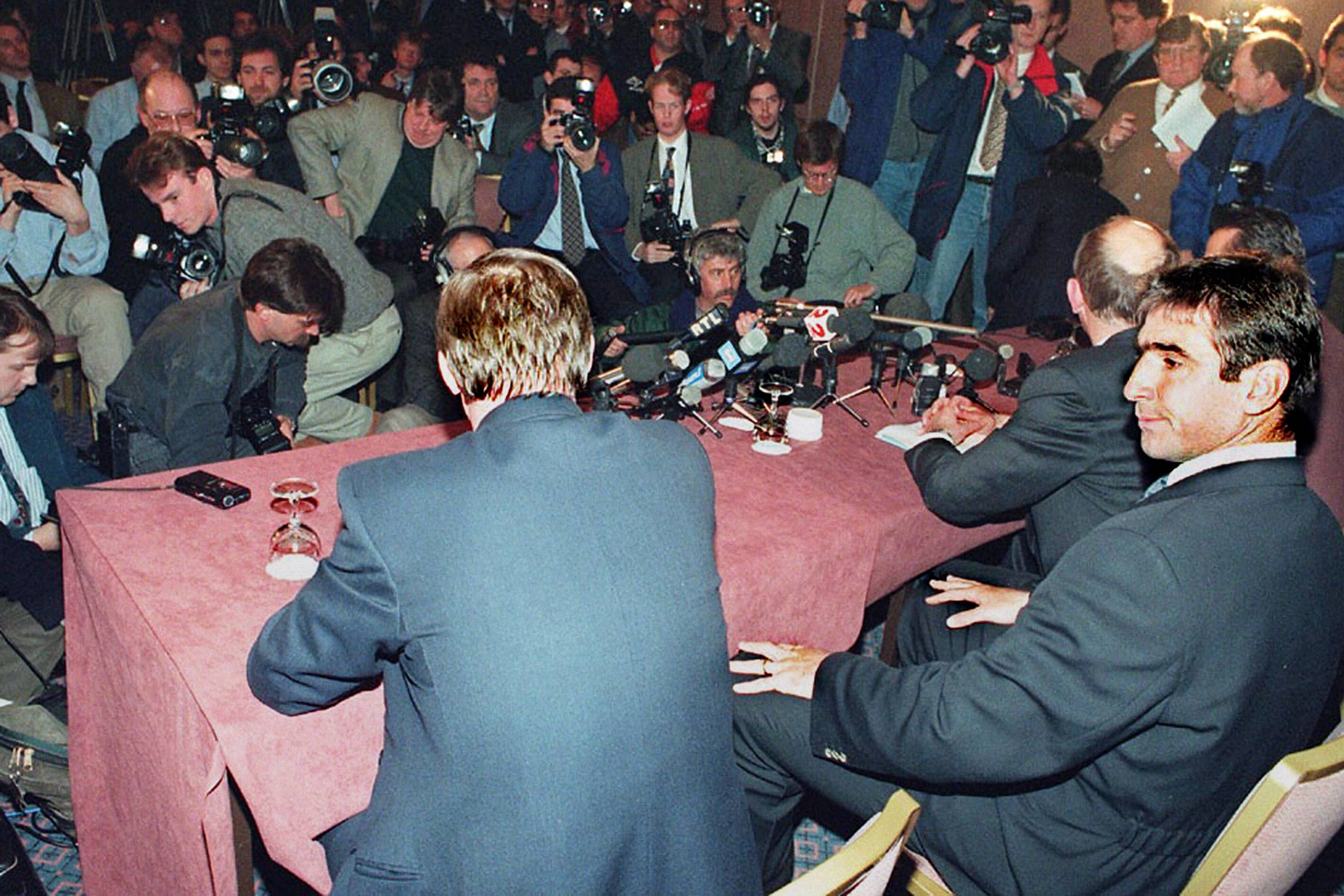 Eric Cantona ao lado do treinador Alex Ferguson numa conferência após a audição disciplinar devido ao pontapé no adepto do Crystal Palace