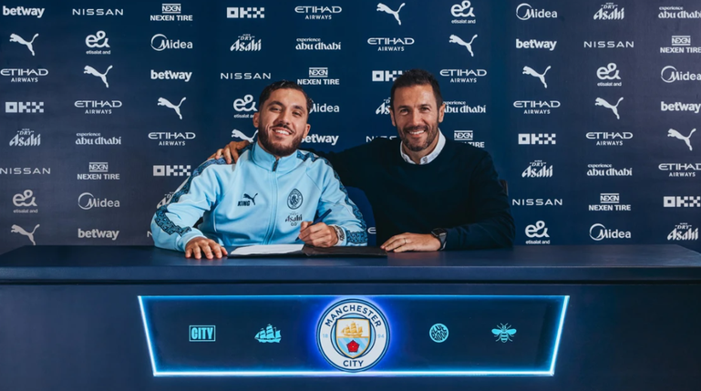 Rayan Cherki a assinar o contrato ao lado de Hugo Viana