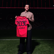 Foto do anúncio de renovação de Musiala com o Bayern, segurando a camisola com o número 2030, validade do contrato