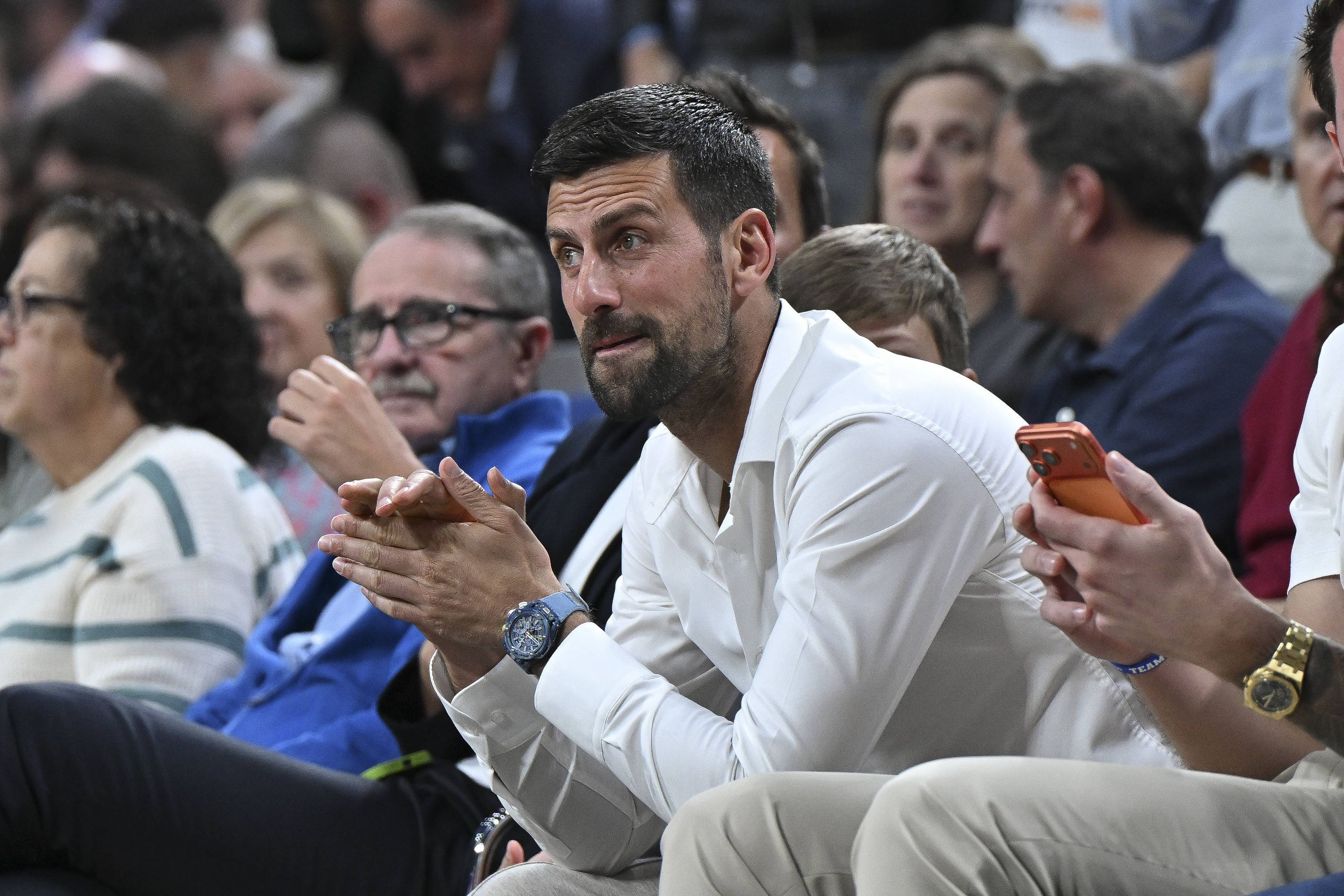Novak Djokovic, lesionado, a assistir a um jogo da Euroliga