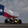 Max Verstappen no carro da Red Bull com a bandeira do Texas atrás