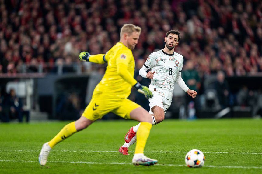 Kasper Scheimechel, guarda-redes da Dinamarca, vai, pressionado por Bruno Fernandes, pontapear a bola para longe. Portugal recebe neste domingo, 23 de março, a Dinamarca e precisa de dar a volta ao 0-1 da primeira mão dos quartos da Liga das Nações