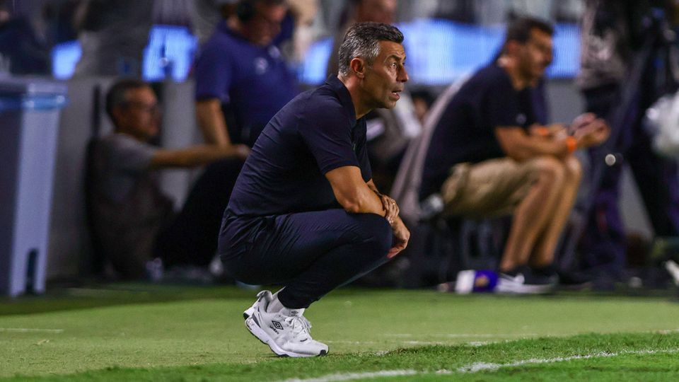 Pedro Caixinha, treinador do Santos, agachado na área técnica