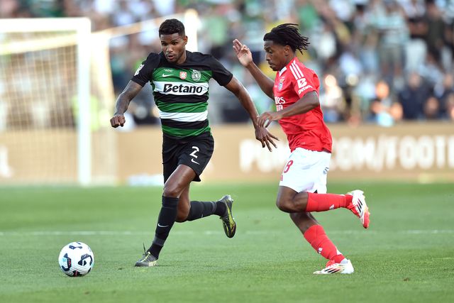 Matheus Reis, defesa do Sporting, conduz a bola perante a oposição de Leandro Barreiro, médio do Benfica