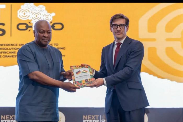 Ambassador Frederik Landshöft presents President John Dramani Mahama with a catalogue documenting provenance research on four cultural objects from Kpando, including two war drums and two war horns.