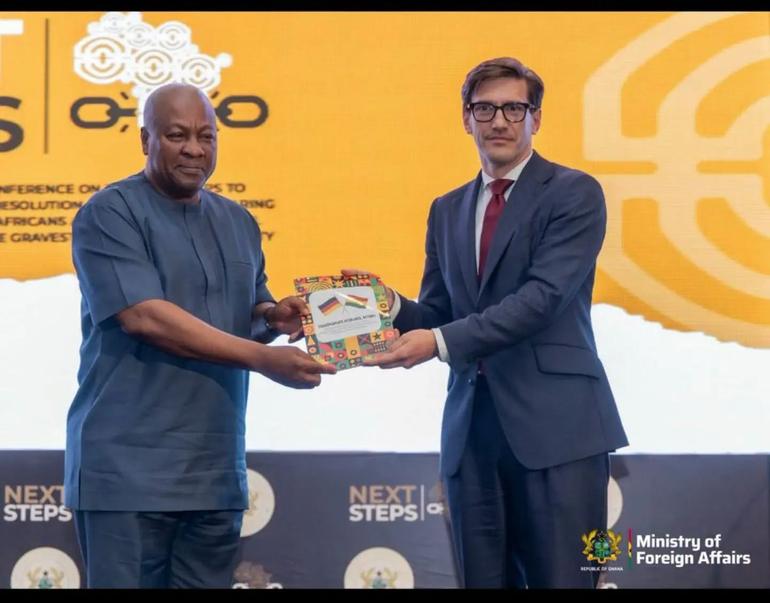 Ambassador Frederik Landshöft presents President John Dramani Mahama with a catalogue documenting provenance research on four cultural objects from Kpando, including two war drums and two war horns.