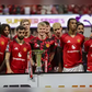Manchester United players pose with the Summer Series trophy after a Premier League Summer Series soccer match against Everton, Sunday, Aug. 3, 2025 in Atlanta. (AP Photo/Colin Hubbard