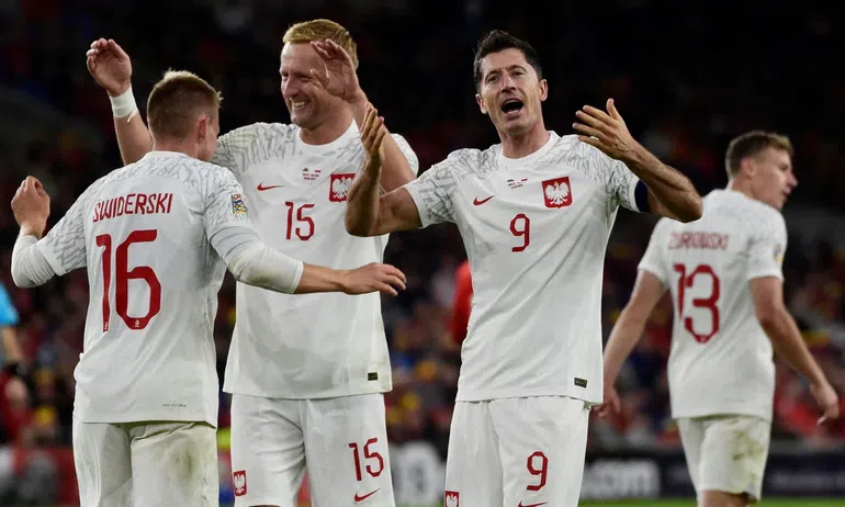 Poland's Karol Swiderski celebrates scoring with Kamil Glik and Robert Lewandowski (right) Photograph: Rebecca Naden/Reuters