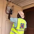An ECG officer installing a meter