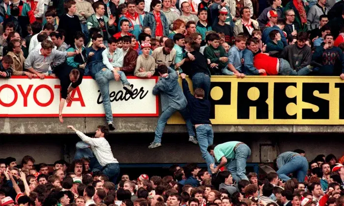 Liverpool supporters try to escape the crush on 15, April 1989. Photograph: Ross Kinnaird/ Empics Sports