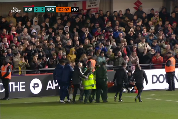 Exeter vs Forest: Ambulance crew rushes to aid Awoniyi after bloody on-pitch collision. Photo credit: ITV