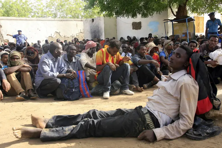Illegal immigrants who were abandoned by traffickers in a remote desert area wait in Dongola, Sudan, after being located by Sudanese and Libyan forces, May 3, 2014. Mohamed Nureldin Abdallah/Reuters