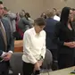 Kouri Richins, center, a Utah mother of three who authorities say fatally poisoned her husband then wrote a children’s book about grieving, stands in court Monday in Park City, Utah. (Rick Bowmer / Associated Press)