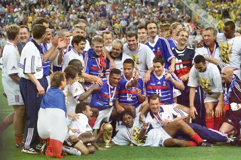 The French team celebrate with the FIFA trophy at the Stade de France after France defeated Brazil 3-0 in the final [Pedro Ugarte/AFP]