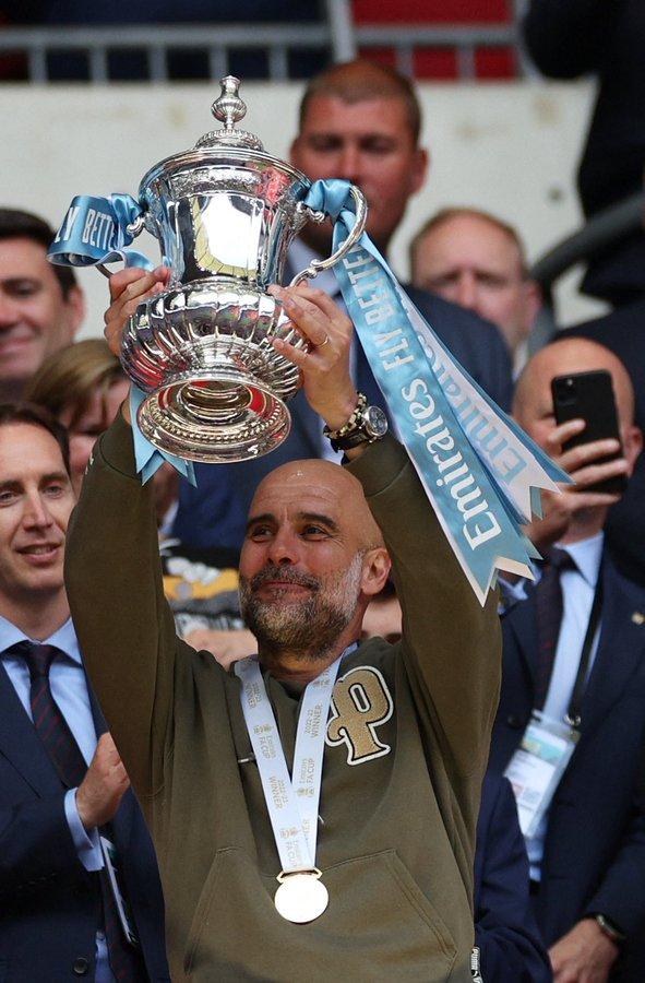 Pep Guardiola lifting FA Cup trohy