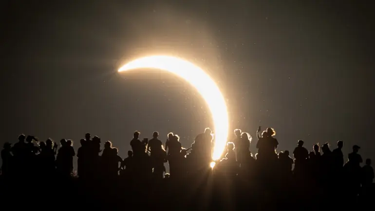 People view the partial solar eclipse besides the historic St. Michael’s Church tower, a Grade I listed building at the top of Glastonbury Tor on August 12, 2026 in Glastonbury, England.
Matt Cardy | Getty Images News | Getty Images