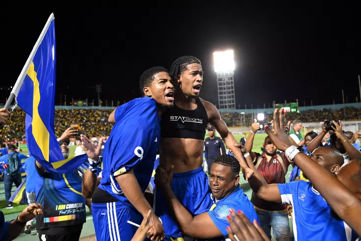 Curaçao players and fans celebrate World Cup 2026 qualification after a 0-0 draw with Jamaica at the National Stadium in Kingston, Jamaica on November 18, 2025. (AFP Photo)