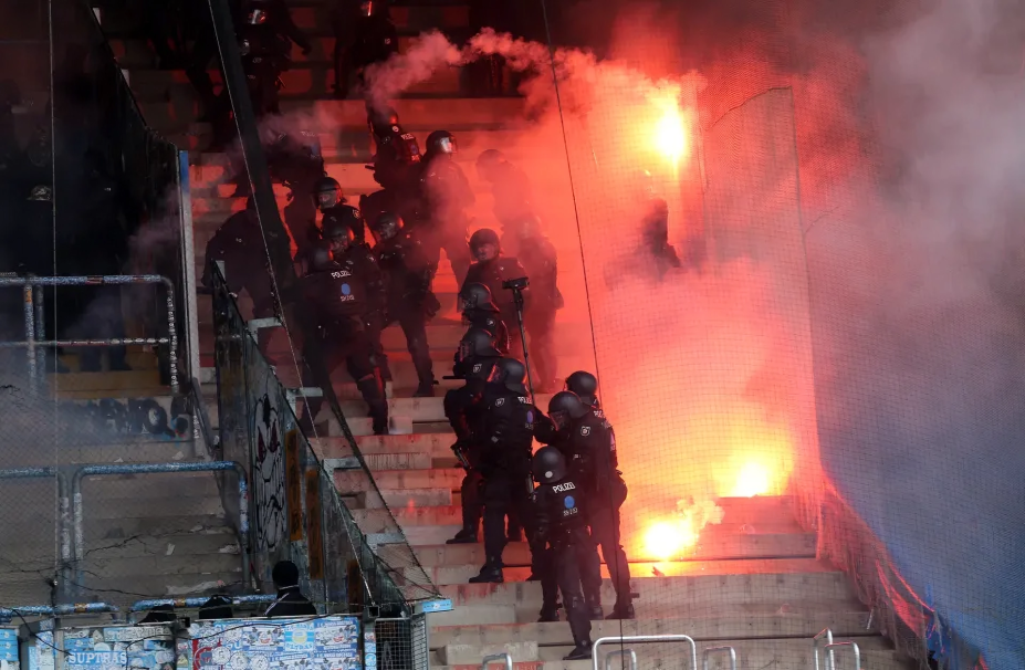 Chaos erupts, match suspended as riot police clash with fans in German league