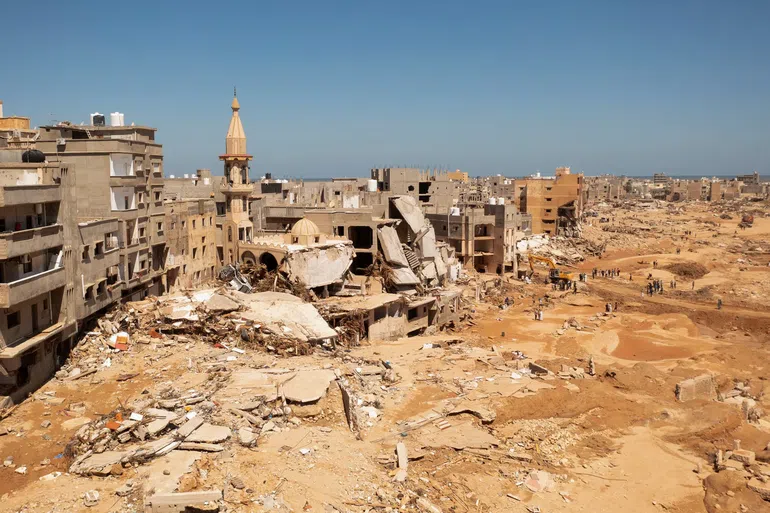 An aerial view of Derna, Libya, on Thursday. Torrential rains burst through two dams near Derna, on Libya’s northeastern coast, destroying much of the city. Credit...Ayman Al-Sahili/Reuters
