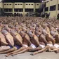 Inmates are lined up during a security operation under the watch of police at Izalco prison in San Salvador, El Salvador, on April 25, 2020. © 2020 El Salvador presidential press office via AP