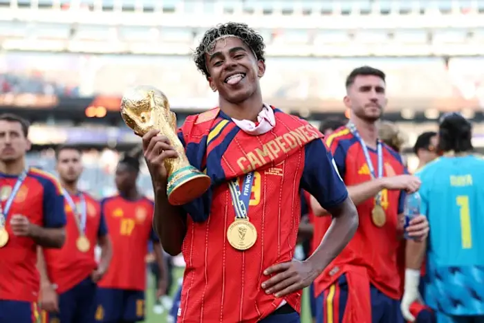 Lamine Yamal #19 of Spain celebrates with the FIFA World Cup Winner’s Trophy after the team’s victory following the FIFA World Cup 2026 Final match between Spain and Argentina (Photo by Alex Pantling - FIFA/FIFA via Getty Images) | FIFA via Getty Images