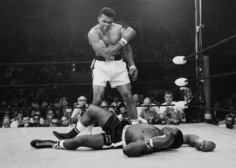 Heavyweight champion Muhammad Ali stands over fallen challenger Sonny Liston, shouting and gesturing shortly after dropping Liston with a short hard right to the jaw on May 25, 1965, in Lewiston, Maine. JOHN ROONEY / AP