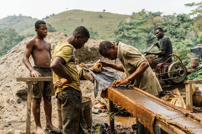 Galamsey miners in Anwiam sift through rock in search of gold. The mining sector has been blamed for changing the color, and quality, of local rivers.
Photograph by Marisa Schwartz Taylor