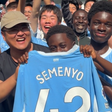 image: A screenshot from the video Manchester City shared of the young fan receiving the shirt