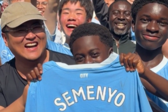 image: A screenshot from the video Manchester City shared of the young fan receiving the shirt
