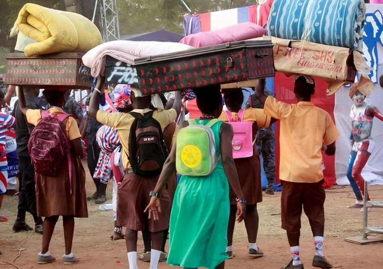 A group of senior high school student carrying their chop boxes and trunks to school
