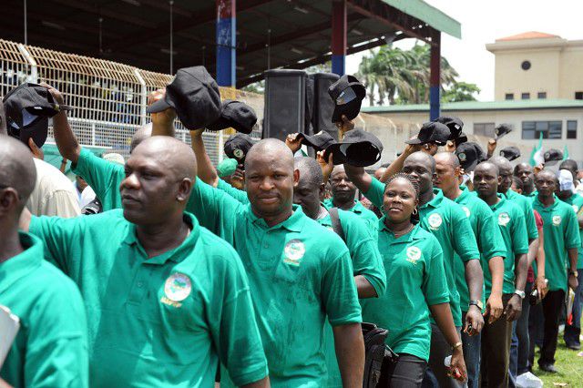 Members of a Nigerian labour union in green-branded shirts marching during the Workers' Day parade.