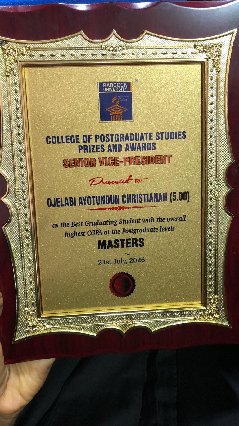 Close-up of the Babcock University award plaque presented to Ojelabi Ayotundun Christianah for achieving a perfect 5.00 CGPA in her Master's degree.