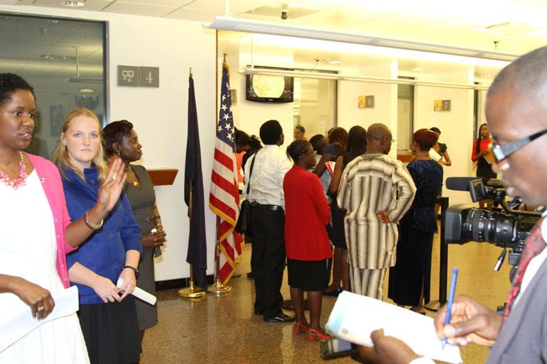 Applicants queueing inside a consular section for a US visa interview appointment in Nigeria.