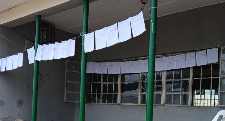 Candidate credential forms suspended along an INEC facility corridor to allow open public inspection.