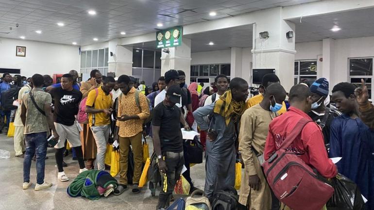Returned Nigerian migrants queueing inside the terminal at Lagos airport with luggage after evacuation from Libya.