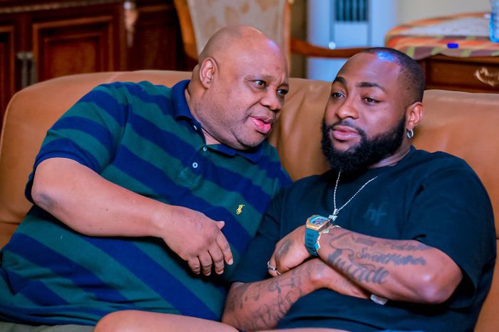 Davido in deep conversation with his uncle, Governor Ademola Adeleke, during a political strategy meeting in Osun State.