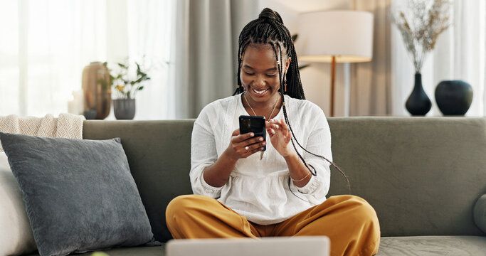 Young Nigerian smiling while using cheap Airtel data on a smartphone
