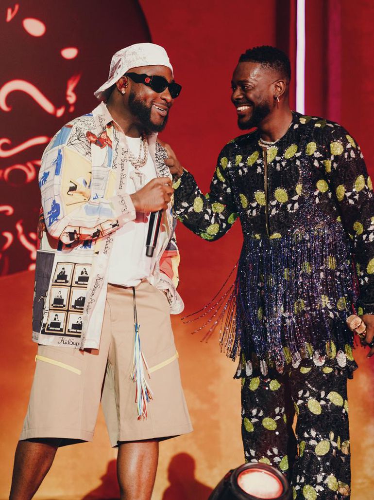 Adekunle Gold on stage with Davido