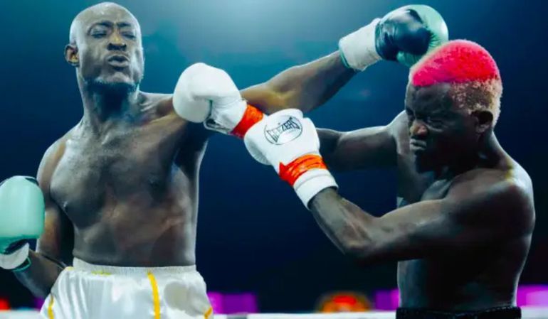 Carter Efe landing a punch on Portable during their celebrity boxing match in Lagos.