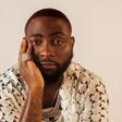A close-up studio portrait of Nigerian Afrobeats star Davido