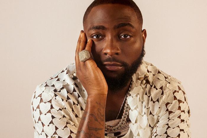A close-up studio portrait of Nigerian Afrobeats star Davido