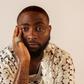 A close-up studio portrait of Nigerian Afrobeats star Davido