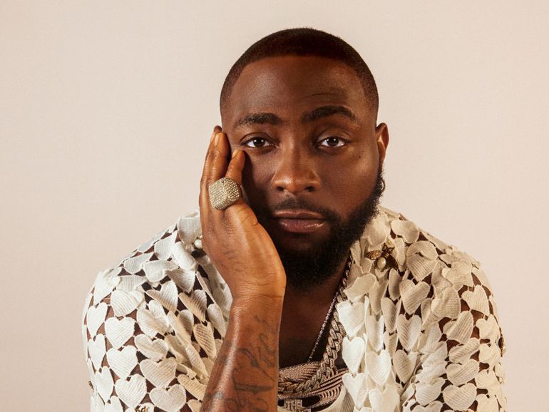 A close-up studio portrait of Nigerian Afrobeats star Davido