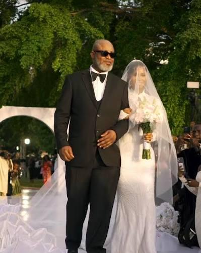 Ademidun Ojo walking Priscilla down the aisle