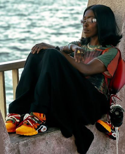 Grace Ladoja, founder of Homecoming, wearing the Nike X Homecoming trainers. 