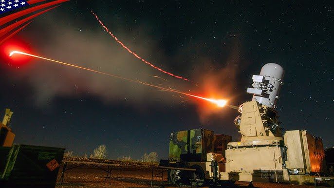 A U.S. Navy Phalanx CIWS Gatling gun firing a steady stream of red tracer rounds into the night sky to intercept incoming drones and missiles.
